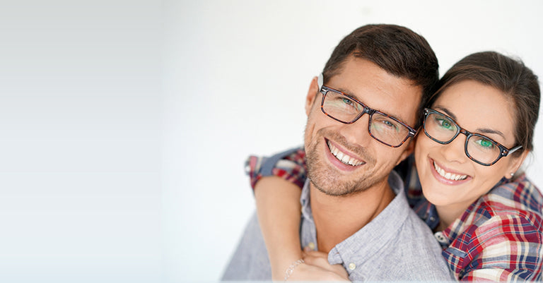 happy couple wearing reader glasses