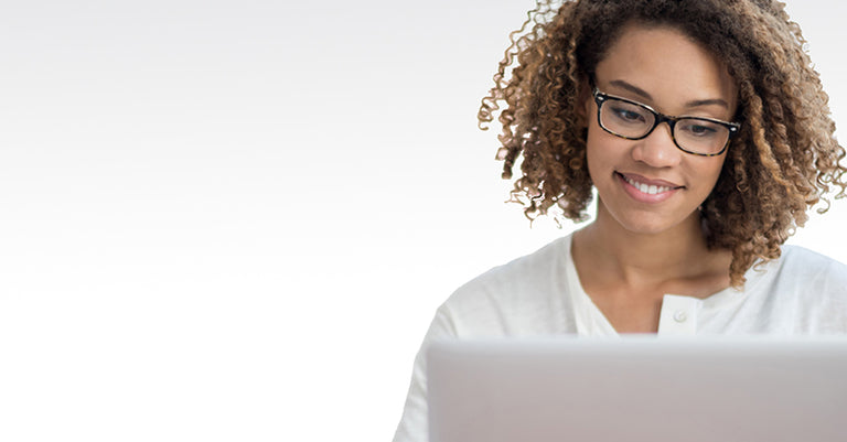 woman looking at computer wearing glasses